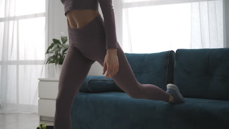 sporty-slim-woman-is-training-in-room-athletic-lady-is-doing-exercises-for-legs-muscles-closeup-of-bottom-body-part-female-sporty-person